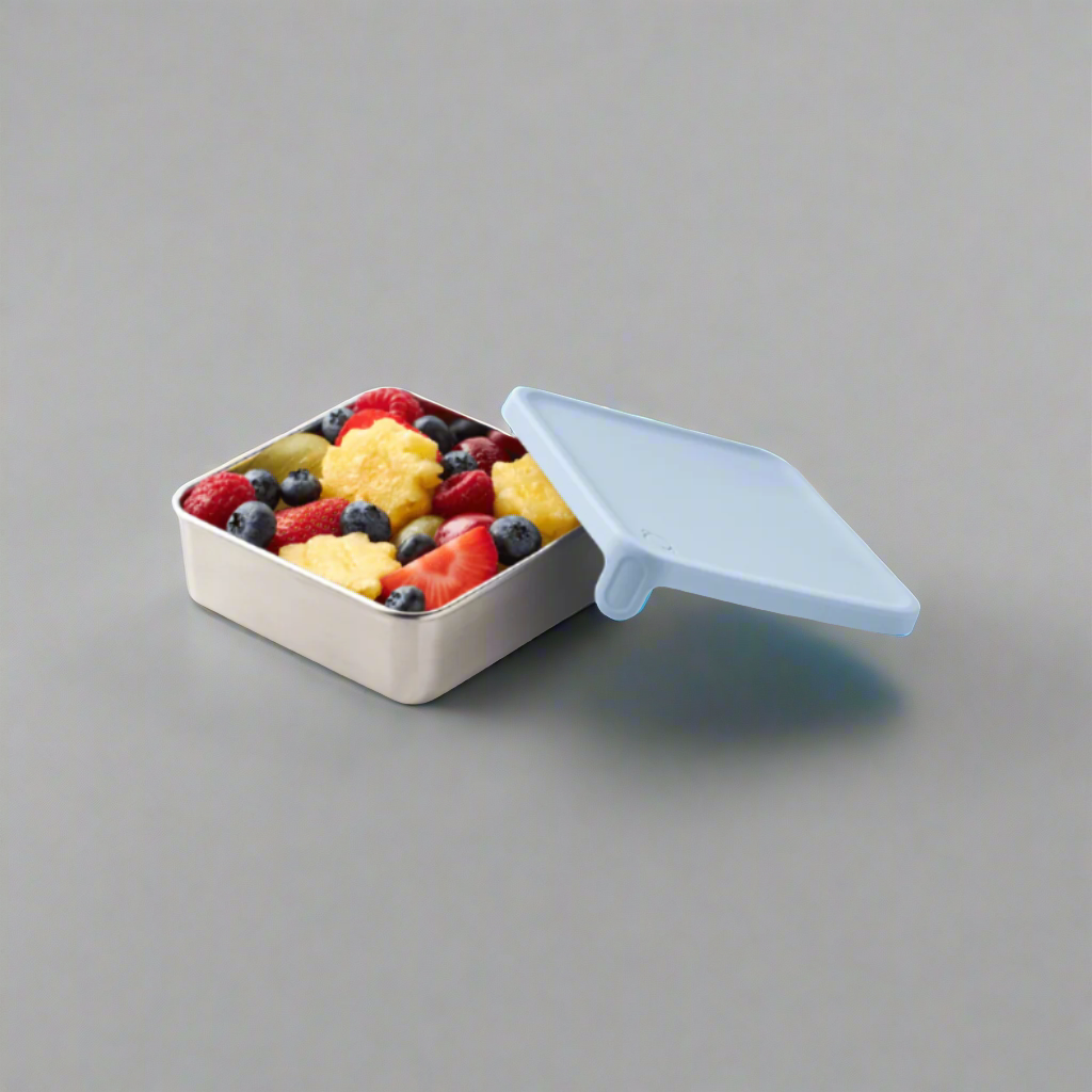 color::Cloudy Day | Light blue silicone lidded container with fruit salad within.