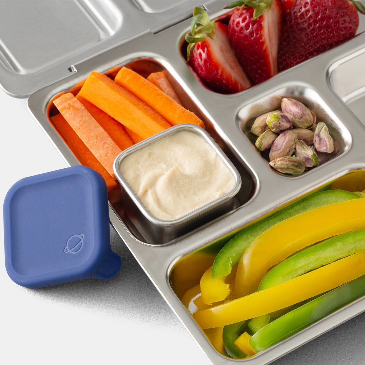 Little Square Dipper filled with sauce inside Rover lunchbox. 